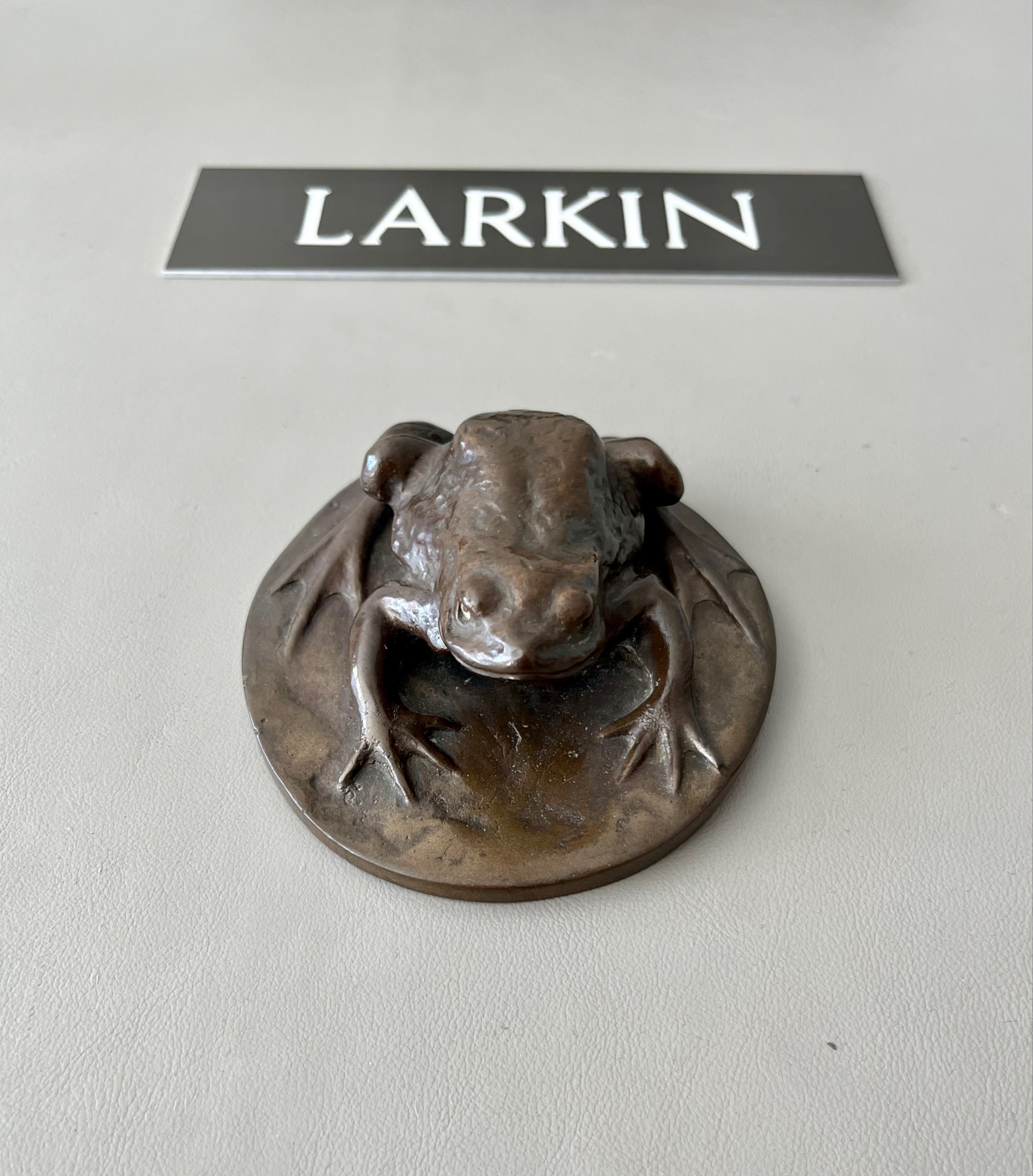 Larkin's toad ornament can be observed in front of Larkin's nameplate.